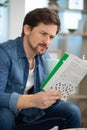 man doing crosswords at home Royalty Free Stock Photo