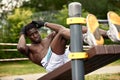 Man doing crunches. Core outdoor workout. Black athlete exercising. Royalty Free Stock Photo