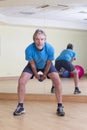 Man doing dumbbell swings Royalty Free Stock Photo
