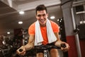 Man doing exercise on elliptical cross trainer in sport fitness gym club