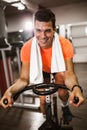 Man doing exercise on elliptical cross trainer in sport fitness gym club