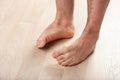 Man doing flatfoot correction gymnastic exercise at home