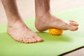 Man doing flatfoot correction gymnastic exercise using massage ball at home Royalty Free Stock Photo