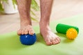 Man doing flatfoot correction gymnastic exercise using massage ball at home Royalty Free Stock Photo