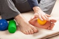 Man doing flatfoot correction self massage at home