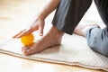 Man doing flatfoot correction self massage at home