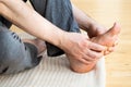 Man doing flatfoot correction self massage at home