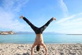 Man doing handstand on the beach Royalty Free Stock Photo