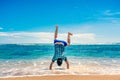 Man doing handstand on the beach Royalty Free Stock Photo