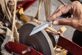 Man doing knife sharpen at iron sharpener from different angle Royalty Free Stock Photo