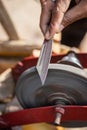 Man doing knife sharpen at iron sharpener from different angle Royalty Free Stock Photo