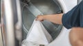 Man doing launder holding basket with dirty laundry of the washing machine in the public store. laundry clothes concept Royalty Free Stock Photo