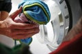Man doing laundry in laundromat, view from the inside of washing Royalty Free Stock Photo