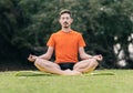 Man doing lotus yoga pose on a mat outdoors Royalty Free Stock Photo