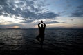 Man doing morning exercises by the sea, Silhouette Royalty Free Stock Photo