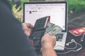 Man doing online shopping with credit card, laptop and luxury snakeskin python wallet. Man online shopping concept. Royalty Free Stock Photo