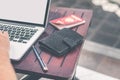 Man doing online shopping with laptop and luxury snakeskin python wallet. Man online shopping concept. Royalty Free Stock Photo