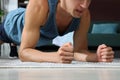 Man doing plank exercise on floor at home, closeup Royalty Free Stock Photo