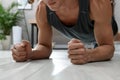 Man doing plank exercise on floor at home, closeup Royalty Free Stock Photo