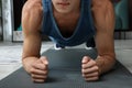 Man doing plank exercise on floor at home, closeup Royalty Free Stock Photo