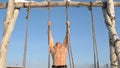 Man doing pull ups utdoors in winter