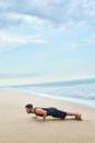 Man Doing Push Up Exercise On Beach. Body Exercising Concept Royalty Free Stock Photo