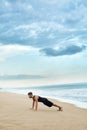 Man Doing Push Up Exercise On Beach. Body Exercising Concept Royalty Free Stock Photo