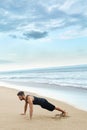 Man Doing Push Up Exercise On Beach. Body Exercising Concept Royalty Free Stock Photo