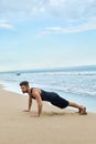 Man Doing Push Up Exercise On Beach. Body Exercising Concept Royalty Free Stock Photo