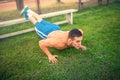 Man doing pushups in park, bodybuilding and training. Fitness concept with shirtless man outdoors, doing exercises Royalty Free Stock Photo