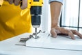 Man doing renovation work at home drilling wood with drill tack on locker Royalty Free Stock Photo