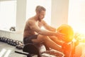 Man doing sit ups with medicine ball on bench, working on abdominal muscles