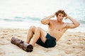 Man Doing Sit-Ups Outdoors on the Beach Royalty Free Stock Photo