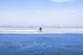 A man doing solo outdoor activity, enjoying time alone in nature, riding a bicycle on frozen lake in winter Royalty Free Stock Photo