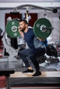 Man doing squats with barbell on neck Royalty Free Stock Photo