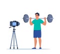 Man doing standing barbell shoulder press exercise recording video with camera on tripod. Social network blogging, healthy