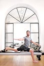 Man doing a standing pilates lunge stretch Royalty Free Stock Photo