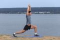 Man doing yoga outdoor. Young man practicing yoga fitness exercise outdoor at beautiful sea.