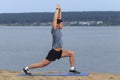 Man doing yoga outdoor. Young man practicing yoga fitness exercise outdoor at beautiful sea. Royalty Free Stock Photo