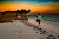A man doing a yoga pose against a golden sunset at Watamu Beach in Malindi, Kilifi County, Kenya Royalty Free Stock Photo