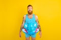 Happy man with inflatable donut with elephant is ready to swim Royalty Free Stock Photo