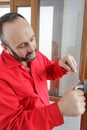 Man during door lock repair Royalty Free Stock Photo