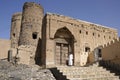 Man in doorway of old mud-brick building, Oman