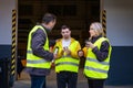 Man with Down syndrome and his colleagues taking break from work, drinking coffee, hot tea outdoors, on loading dock Royalty Free Stock Photo