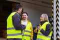 Man with Down syndrome and his colleagues taking break from work, drinking coffee, hot tea outdoors, on loading dock Royalty Free Stock Photo