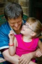 Man With Downs Syndrome Holds His Young Neice As She Laughs