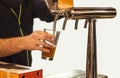 Man drawing beer from tap Royalty Free Stock Photo