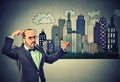 Man drawing city skyline on gray wall background Royalty Free Stock Photo