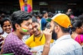 A man drawing an indian flag on customer`s face