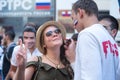 Man drawing russian flag on the cheek of the young woman sport fan Royalty Free Stock Photo